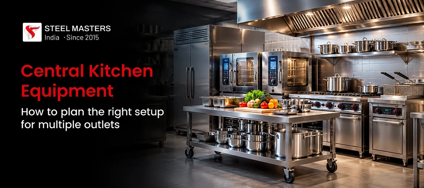 Steel Masters banner on central kitchen equipment, showing stainless-steel ovens, counters, and fresh produce in a clean, professional kitchen.